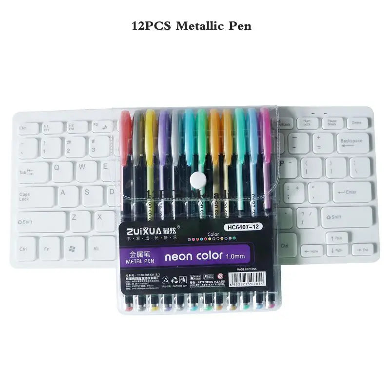 A set of 12 metallic pens in various colors displayed next to a white mechanical keyboard.