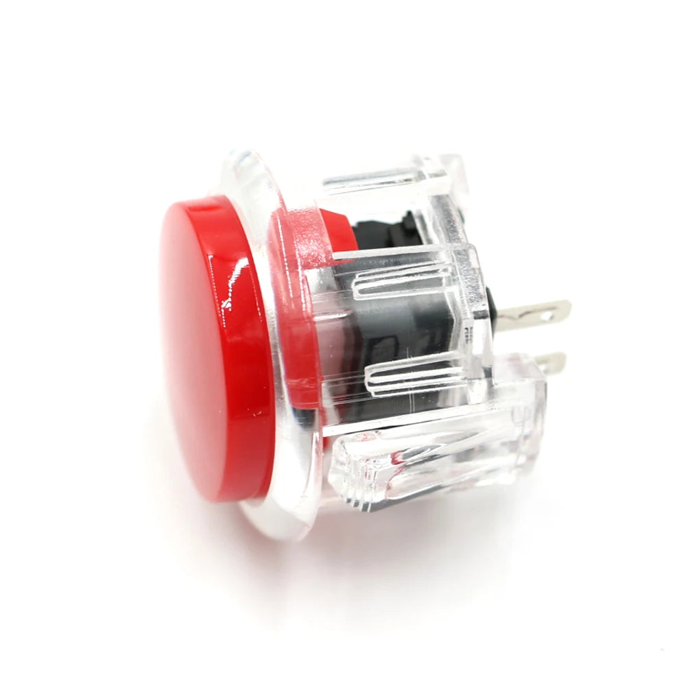 A clear plastic arcade push button game switch with a red component and metal pins.