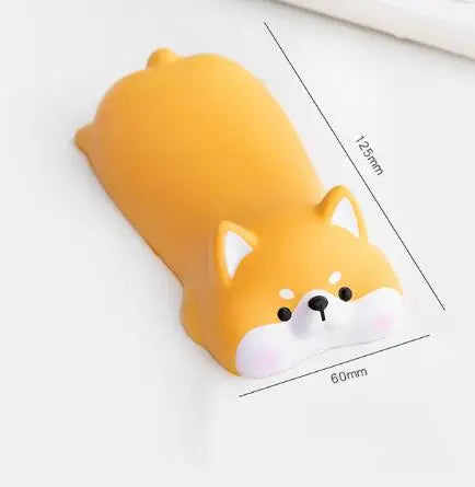 A yellow, ergonomic wrist rest shaped like a fox head for use with a mouse or keyboard.