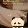 A glowing panda silicone night light rests on a surface, illuminating the surrounding area.
