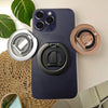 A dark blue phone case featuring a MagSafe double-sided ring holder in silver and rose gold tones.