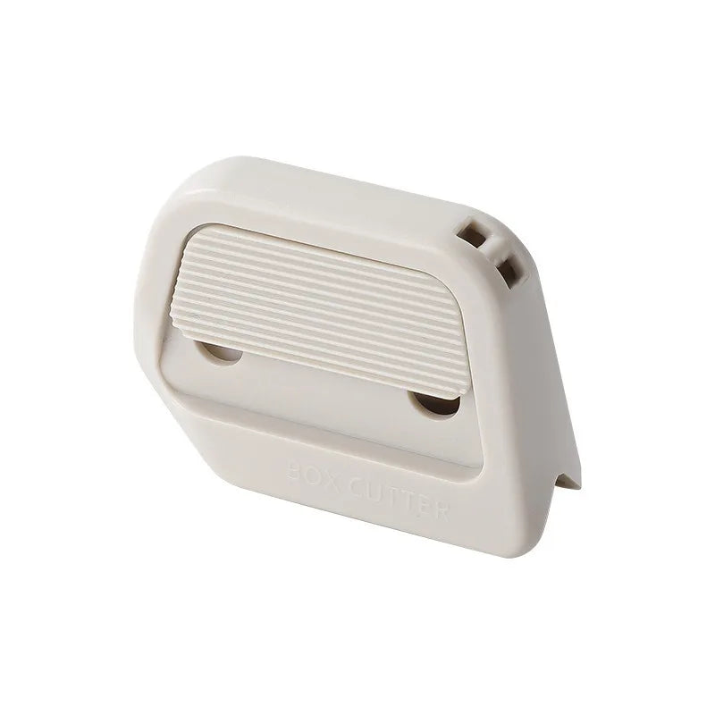A white mini ceramic box cutter with an auto-retractable blade shown from the side.