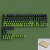 A close-up view of a green mechanical keyboard featuring Gradient Gray double shot PBT keycaps with side printing.