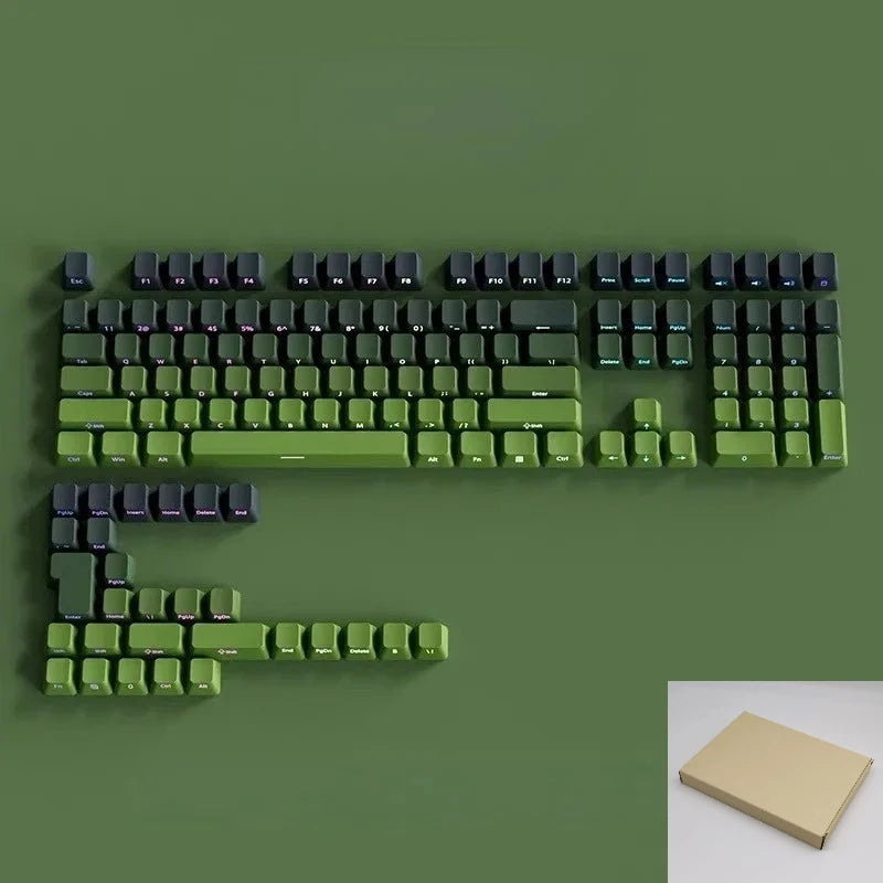 A close-up view of a green mechanical keyboard featuring Gradient Gray double shot PBT keycaps with side printing.