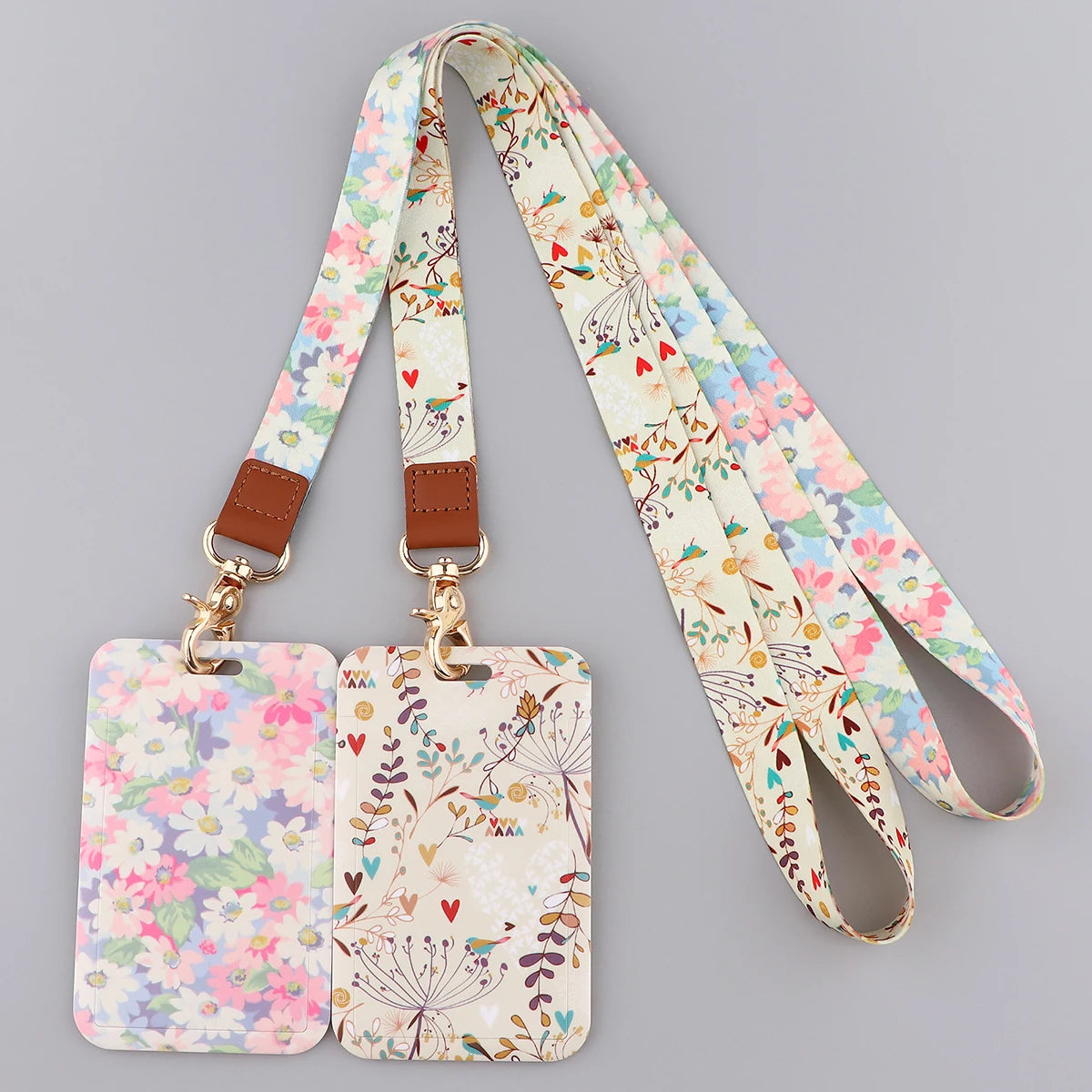 A beige floral patterned fashion lanyard strap with a brown leather attachment and ID badge holder tag.