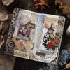 A handmade paper craft featuring floral and nature elements with silver stamping lace tape on a rustic background.