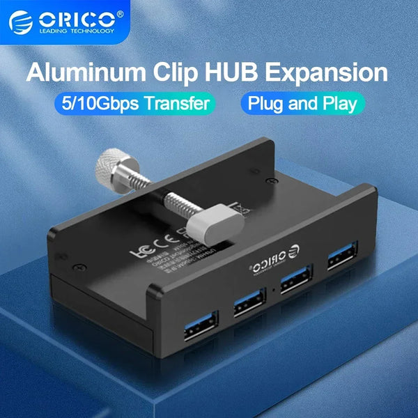 A black Aluminum Clip HUB Expansion device with multiple USB ports and a clip visible on a blue surface.