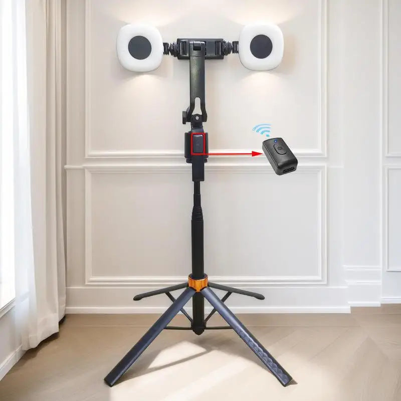 A black tripod selfie stick with dual lights and face tracking is mounted on a floor stand.