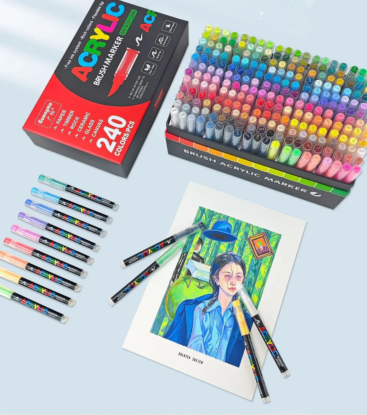 A set of 240 acrylic brush markers in various colors and shades displayed in a box and loose.