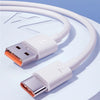 A white USB-C fast charging cable with braided nylon design shown coiled on a light blue surface.
