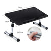 A black portable adjustable laptop desk stand with a flat surface and folding legs.