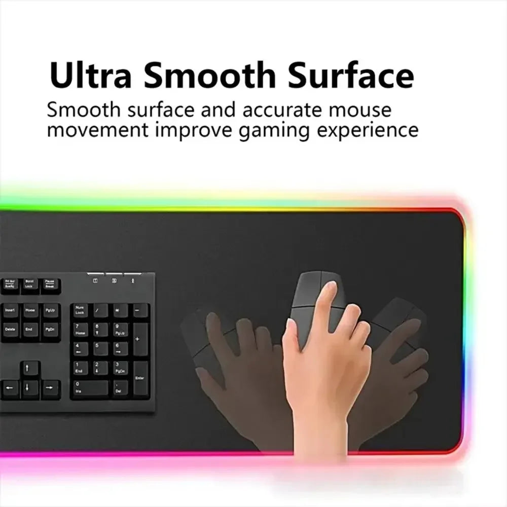 A hand is using an ultra smooth surface gaming mouse pad with RGB lighting on a dark desk.