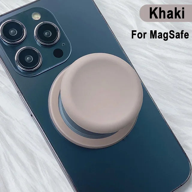 A dark blue phone case featuring a khaki silicone magnetic grip stand for MagSafe compatibility.