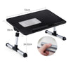 A black portable adjustable laptop desk stand with a textured surface and silver adjustable legs.
