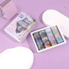 A set of oil painting themed decorative washi tape rolls displayed next to a sketchbook and on a purple background.