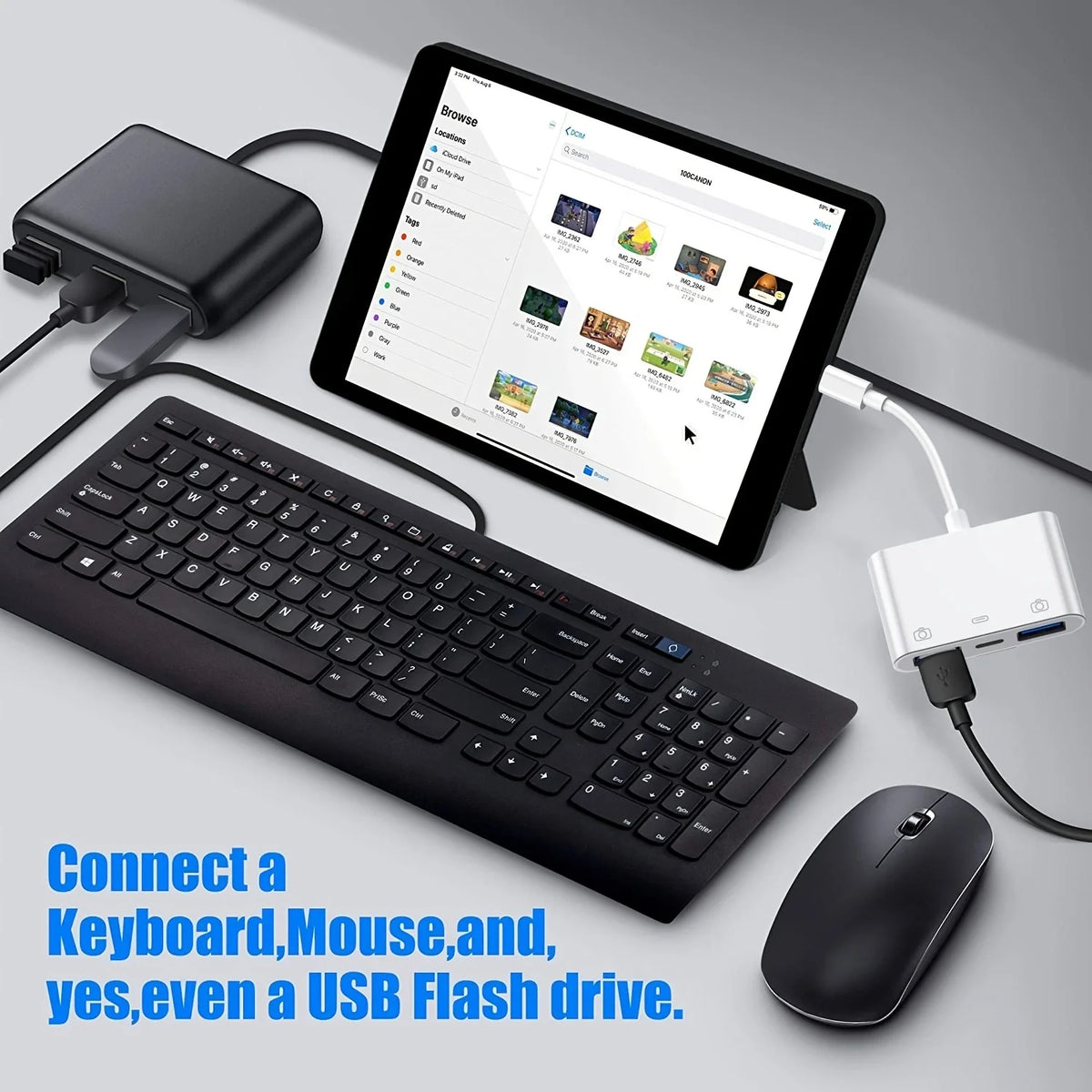 A black keyboard, mouse, and tablet are shown with a USB flash drive connected to them.