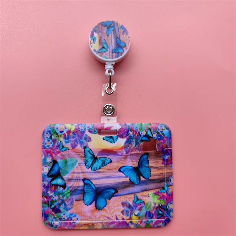 A colorful plastic card holder clip featuring butterfly designs, set against a pink background.