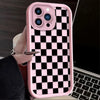 A pink silicone phone case with a black and white checkered pattern is shown being held by a hand.