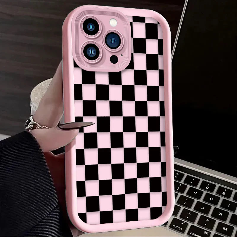A pink silicone phone case with a black and white checkered pattern is shown being held by a hand.