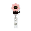 A pink flower-shaped charm attached to a silver retractable ID badge holder with a crocodile clip.