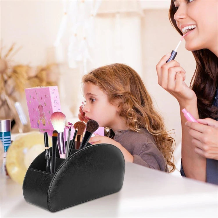 A young girl is using a makeup brush on her lip while a black PU leather caddy organizer filled with various makeup brushes i