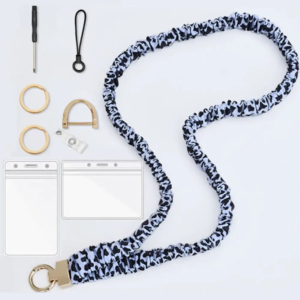 A stylish stretchy breakaway ID badge lanyard with a black and white leopard print strap and gold-toned hardware.