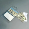 A clear plastic binder holds US dollar bills and a January document.