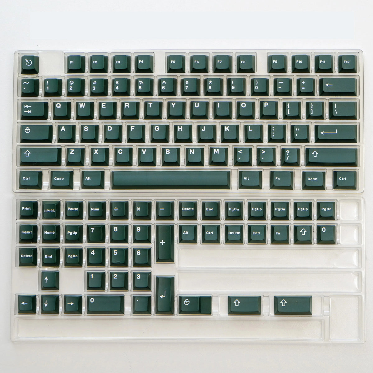 A close-up view of a dark green mechanical keyboard featuring PBT keycaps and a cherry profile.