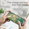 A hand holds a smartphone displaying text about fast charging and playing games, next to a USB-C to 3.5mm audio adapter.