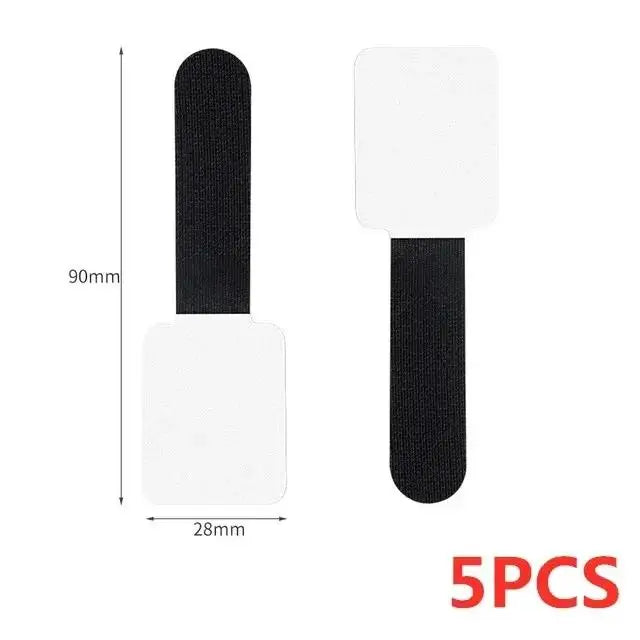 Five reusable white and black adhesive cable ties for desk organization
