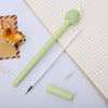 A light green cartoon fruit shaped gel pen with a yellow tip and a white pen, resting on lined paper.