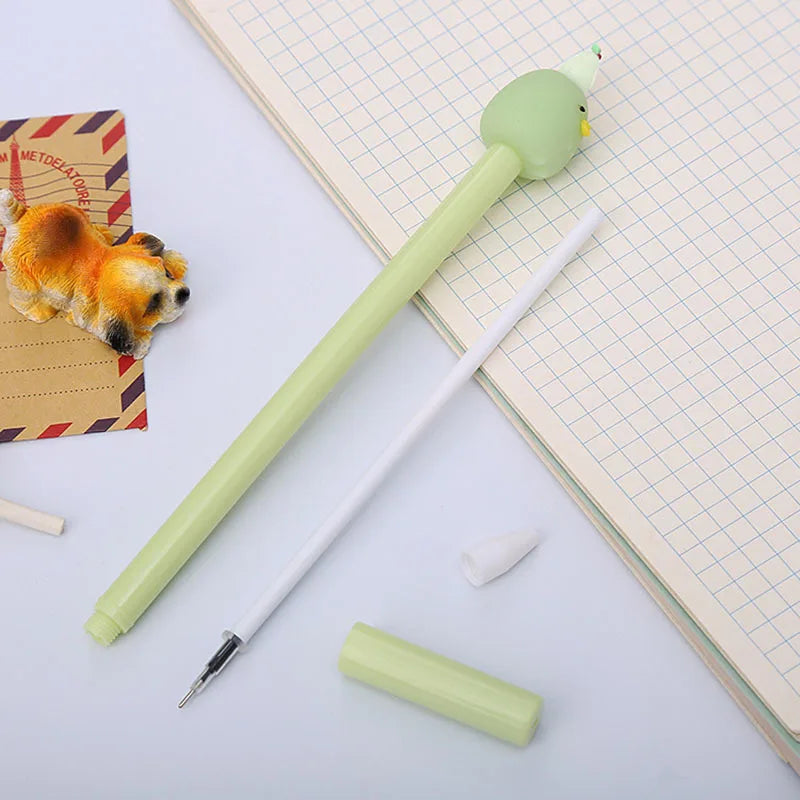 A light green cartoon fruit shaped gel pen with a yellow tip and a white pen, resting on lined paper.