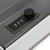 A black combination lock safe box with a round dial and four numbered buttons is shown on a dark surface.