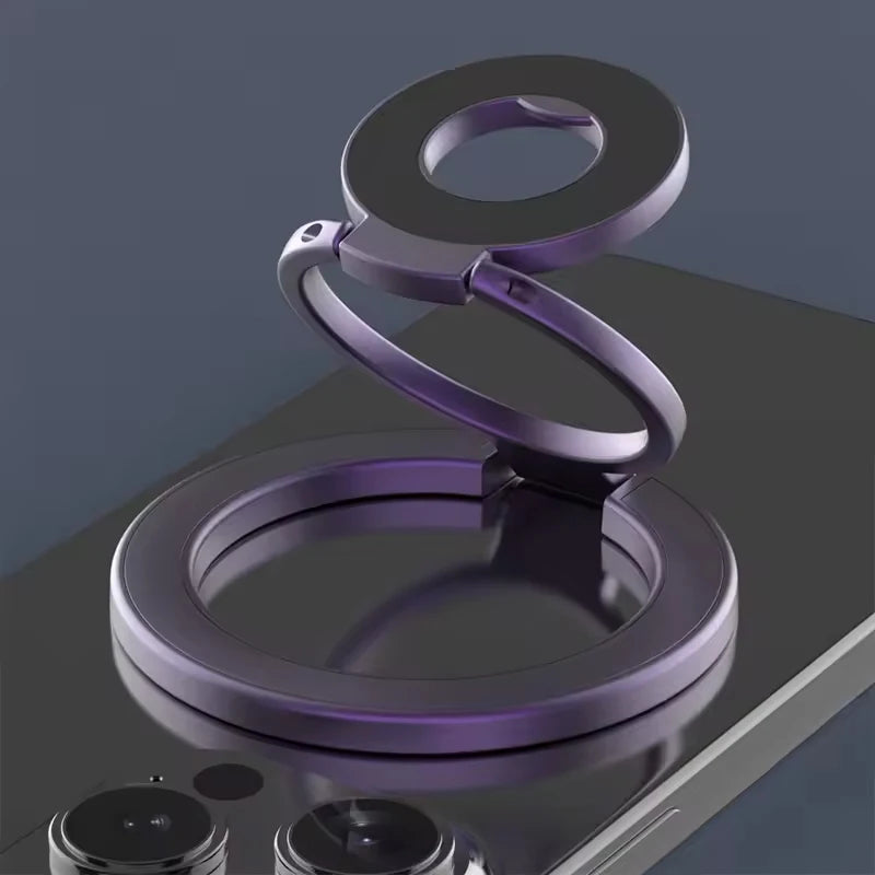 A purple MagSafe double-sided phone ring holder stand resting on a dark surface.