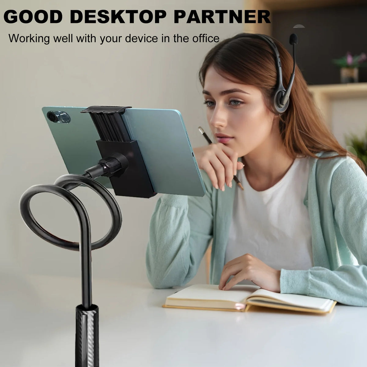 A woman is using a 360° rotating tablet and phone stand with a flexible spiral base on a desk.