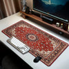 A vintage Persian rug mouse pad with a non-slip rubber base is displayed on a white desk next to a computer monitor and keybo