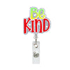 A sparkly acrylic badge holder with the text Be Kind in green and pink.