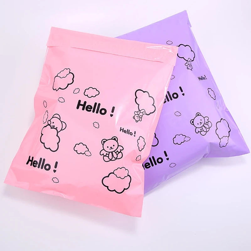 Two pink and purple reusable plastic mailing bags with cloud and hello doodles