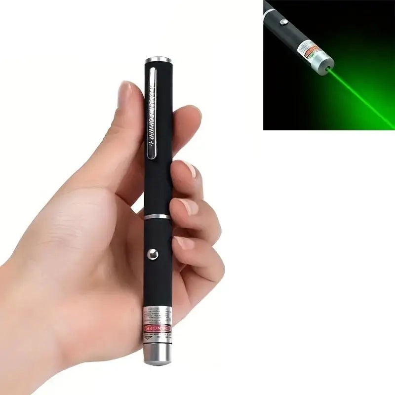 A hand holds an interactive pet training pen with a green light beam emitting from the tip.