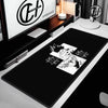 A black extra large gaming mouse pad featuring a white illustration of a character's face and hair.