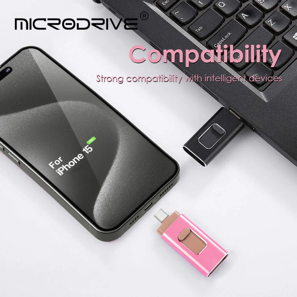 A black iPhone 15 smartphone next to a black computer keyboard and a pink USB flash drive.