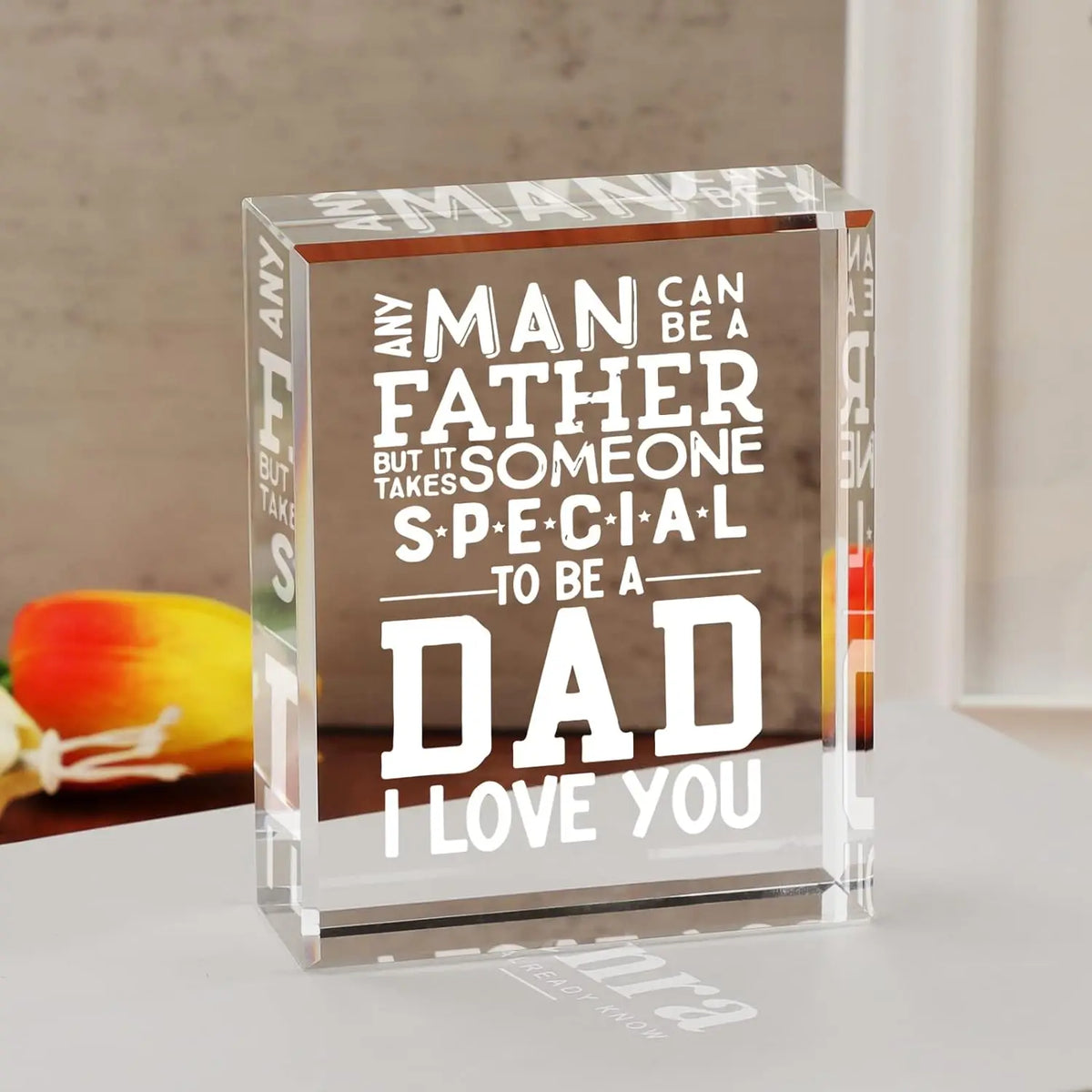 A clear glass cube engraved with the text Any man can be a father but it takes someone special to be a dad and I love you