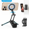 Soporte magnético negro para teléfono con soporte circular, junto a un smartphone y un soporte portátil.