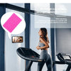 A woman is using a silicone suction cup phone holder on a workout machine, demonstrating its stability for exercising.