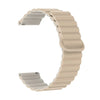 A beige adjustable magnetic loop watch band shown in a curved shape.