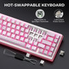 A pink hot-swappable mechanical keyboard with linear switches and a switch removal tool.