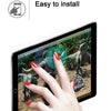 A hand is installing an HD tempered glass screen protector on an iPad, demonstrating the easy installation process.