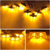 A close-up view of multiple wireless LED emergency strobe lights illuminating a dark surface.