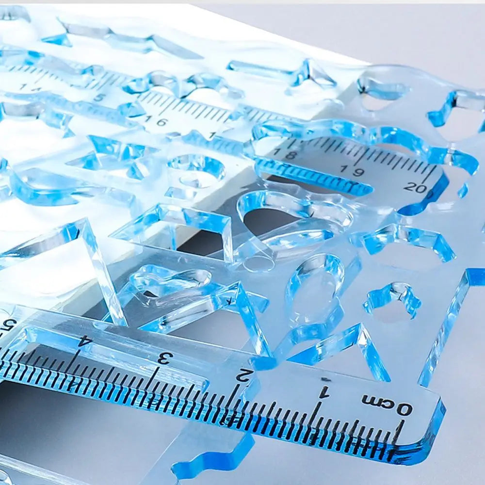 A set of clear blue multi-shape geometric drawing templates and a ruler with centimeter markings.