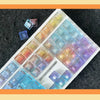 A collection of colorful rainbow shine PC keycaps arranged on a white tray.